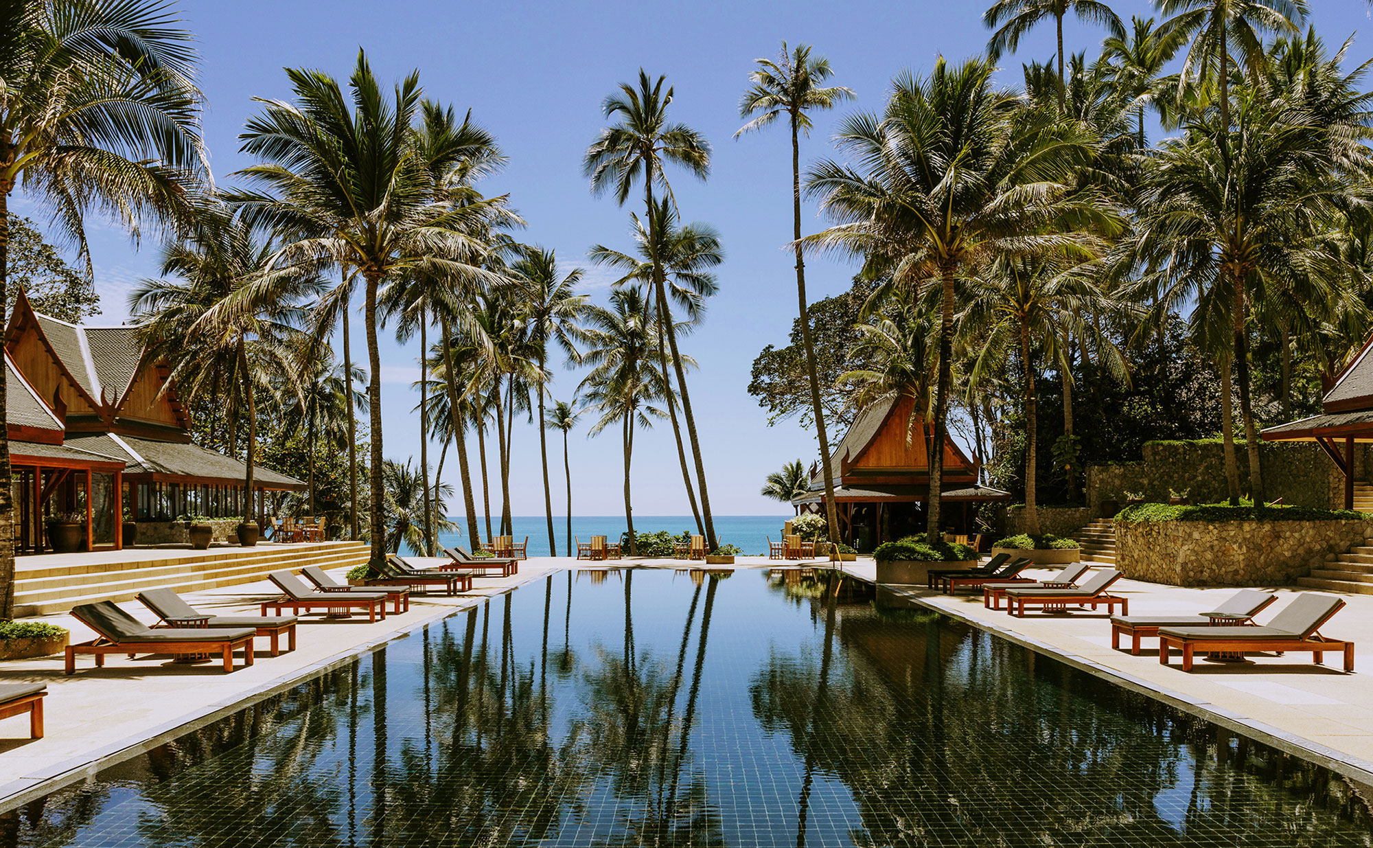 A private infinity pool pavilion at Amanpuri, overlooking the turquoise waters of the Andaman Sea in Phuket, Thailand, conceptualized by Throne Voyages.
